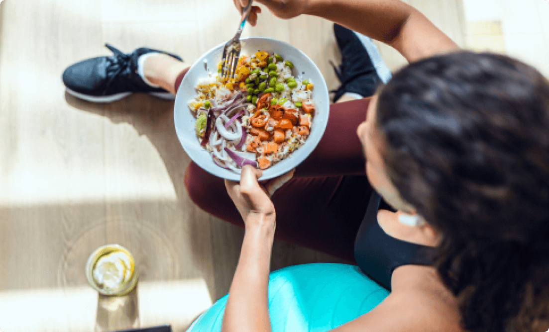 girl holding a bowl of salad.