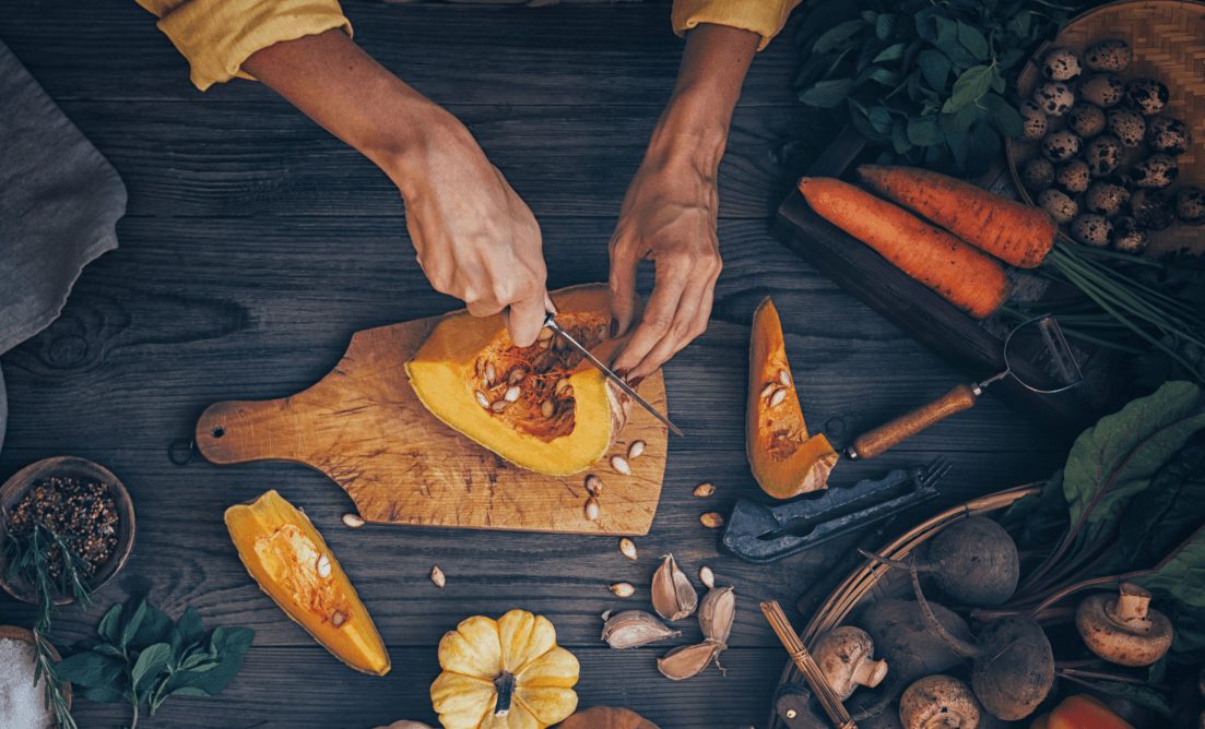  A women cutting a pumpkin on Halloween