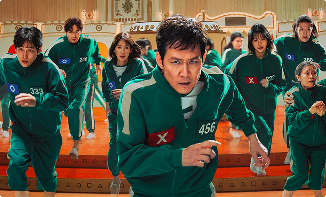 Contestants in green tracksuits running in a tense moment from the show Squid Game, showcasing the intense and high-stakes nature of the competition.